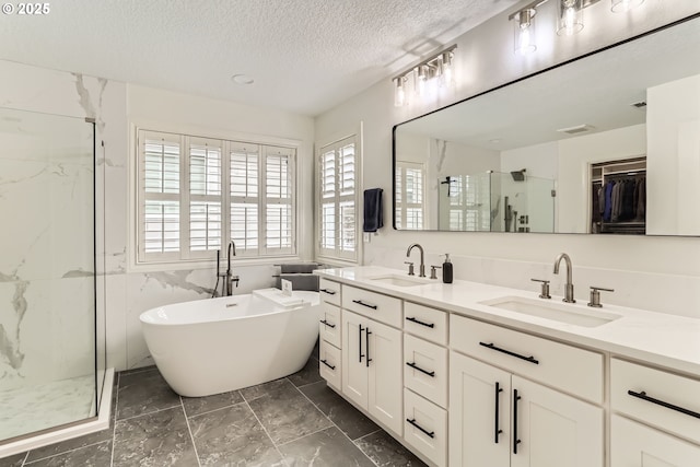 18350 SW Florendo Ln, Beaverton, OR 97007 - bathroom featuring visible vents, a textured ceiling, a sink, and a marble finish shower