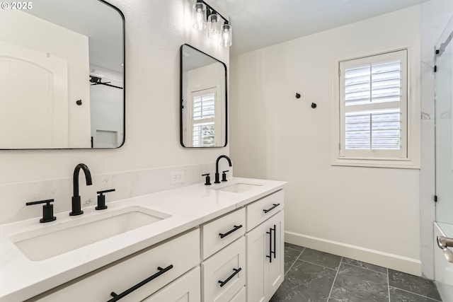 18350 SW Florendo Ln, Beaverton, OR 97007 - bathroom featuring double vanity, a sink, a ceiling fan, and baseboards