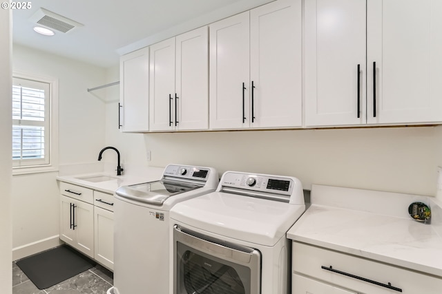 18350 SW Florendo Ln, Beaverton, OR 97007 - clothes washing area with visible vents, baseboards, a sink, cabinet space, and washer and clothes dryer