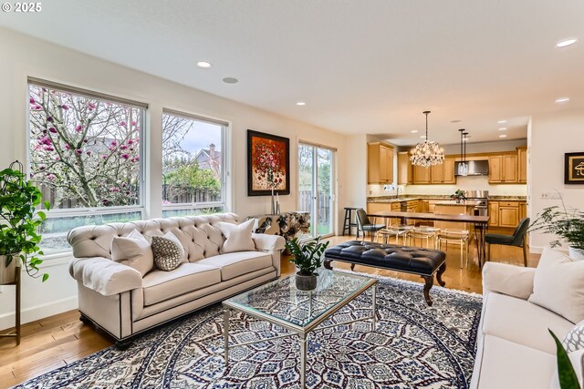 18350 SW Florendo Ln, Beaverton, OR 97007 - living room with baseboards, recessed lighting, a notable chandelier, and wood finished floors