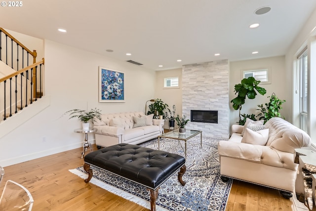 18350 SW Florendo Ln, Beaverton, OR 97007 - living room with wood finished floors, recessed lighting, visible vents, and stairs