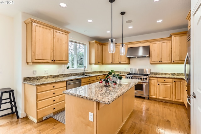 18350 SW Florendo Ln, Beaverton, OR 97007 - kitchen with wall chimney range hood, a kitchen island, stainless steel appliances, light wood finished floors, and light brown cabinets