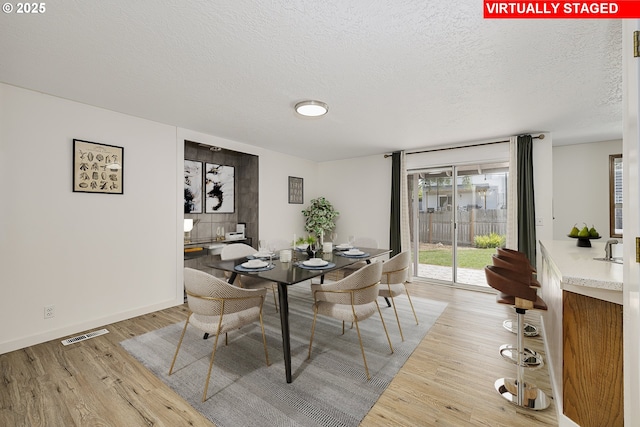 13326 SW Shore Dr, Portland, OR 97223 - dining area with light wood-style flooring and a textured ceiling