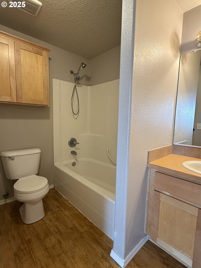 539 NW Blair Loop, Sheridan, OR 97378 - bathroom featuring a textured ceiling, wood finished floors, toilet, vanity, and baseboards