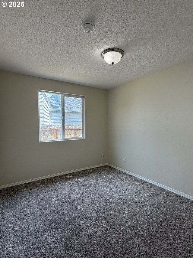 539 NW Blair Loop, Sheridan, OR 97378 - empty room with carpet flooring, baseboards, a textured ceiling, and a smoke detector