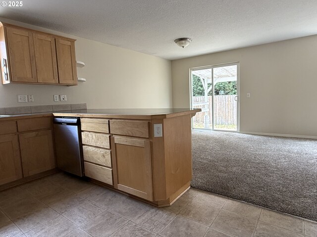 539 NW Blair Loop, Sheridan, OR 97378 - kitchen featuring dishwasher, a peninsula, light carpet, a textured ceiling, and light countertops