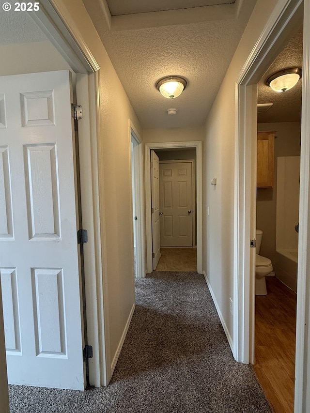 539 NW Blair Loop, Sheridan, OR 97378 - corridor featuring a textured ceiling, baseboards, and carpet flooring