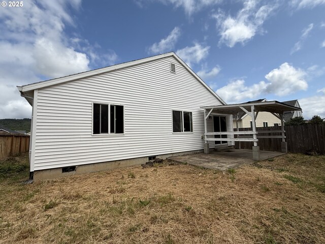 539 NW Blair Loop, Sheridan, OR 97378 - back of property featuring crawl space, fence, and a patio area