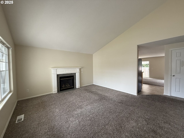 539 NW Blair Loop, Sheridan, OR 97378 - unfurnished living room with lofted ceiling, carpet floors, a fireplace with flush hearth, and baseboards
