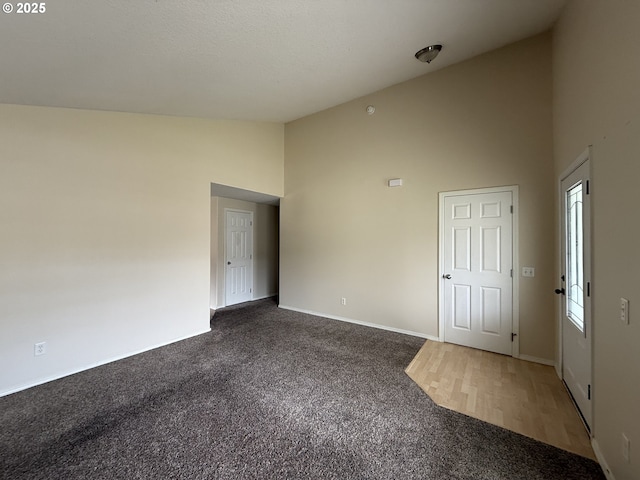 539 NW Blair Loop, Sheridan, OR 97378 - carpeted spare room with high vaulted ceiling and baseboards