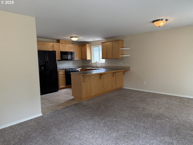 539 NW Blair Loop, Sheridan, OR 97378 - kitchen featuring black appliances, a peninsula, a breakfast bar area, light colored carpet, and baseboards