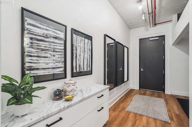 foyer with wood finished floors and baseboards
