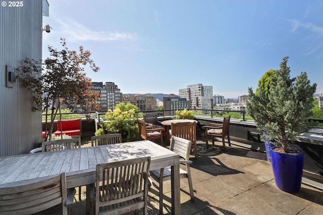 view of patio / terrace featuring a city view and outdoor dining area