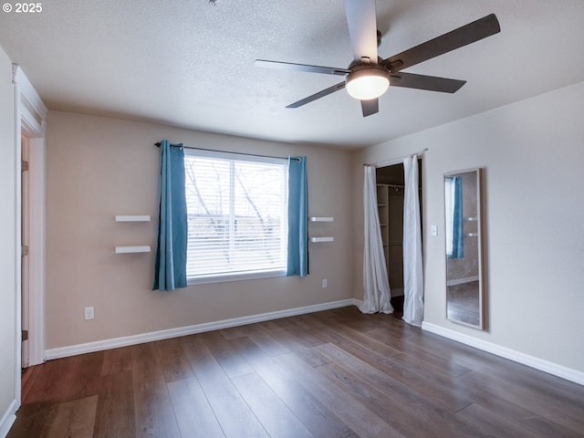 unfurnished bedroom featuring ceiling fan, dark hardwood / wood-style floors, and a textured ceiling