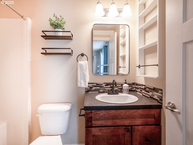 bathroom featuring vanity, tasteful backsplash, and toilet