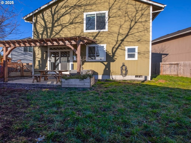 back of property with a yard, a patio area, and a pergola