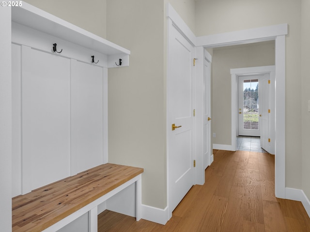 mudroom featuring light wood-type flooring and baseboards