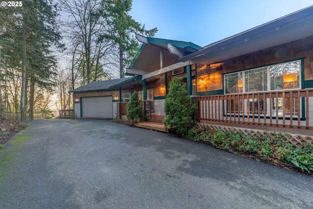 property exterior at dusk featuring a garage