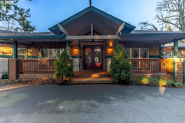 view of front facade featuring a porch and french doors