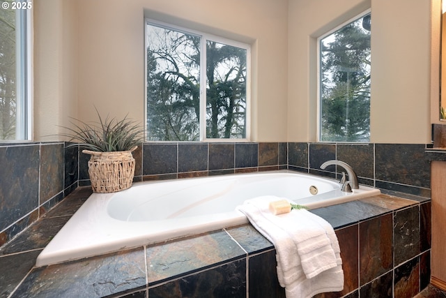 bathroom with a relaxing tiled tub