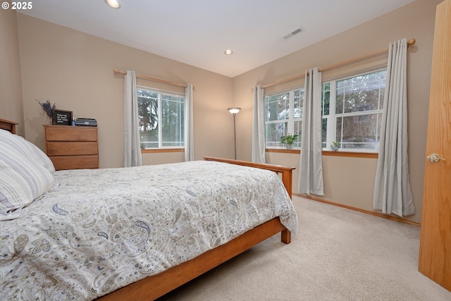 carpeted bedroom featuring multiple windows