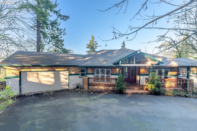 ranch-style home with a wooden deck and a garage