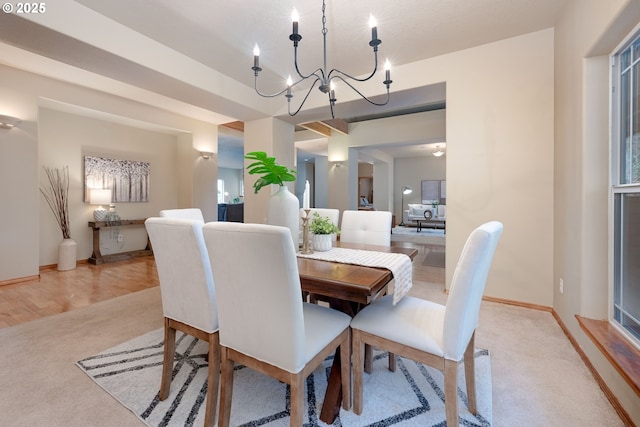 dining room featuring light colored carpet and a chandelier