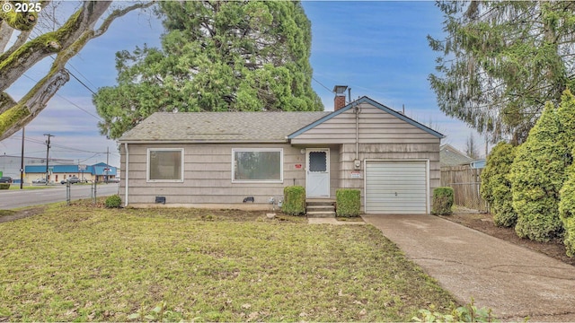 view of front of house with a front lawn and a garage