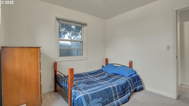 bedroom featuring light carpet