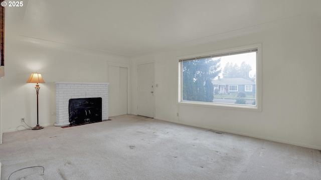 unfurnished living room with a fireplace and carpet flooring