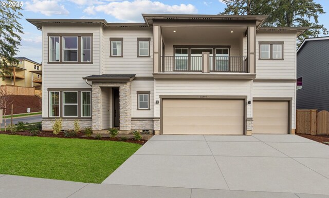 view of front facade with a garage and a balcony