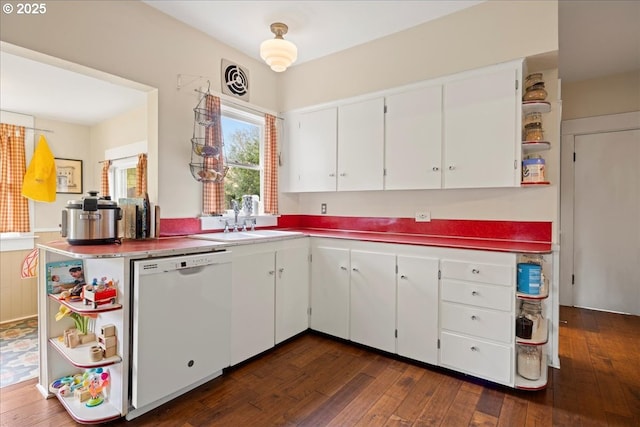 kitchen with dishwasher, dark hardwood / wood-style floors, sink, and white cabinets