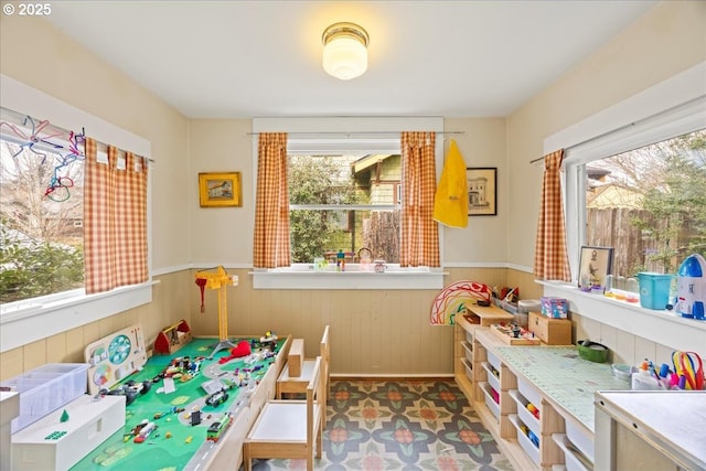 recreation room featuring wooden walls