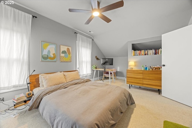 carpeted bedroom featuring ceiling fan and vaulted ceiling