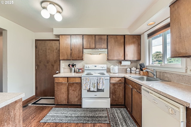 617 NW Fariss Rd, Gresham, OR 97030 - kitchen with white appliances, a sink, under cabinet range hood, dark wood-style floors, and light countertops