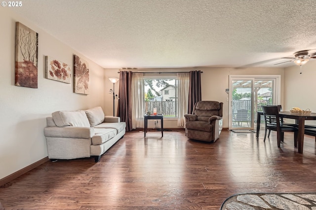 617 NW Fariss Rd, Gresham, OR 97030 - living room with healthy amount of natural light, a textured ceiling, dark wood-style floors, and ceiling fan