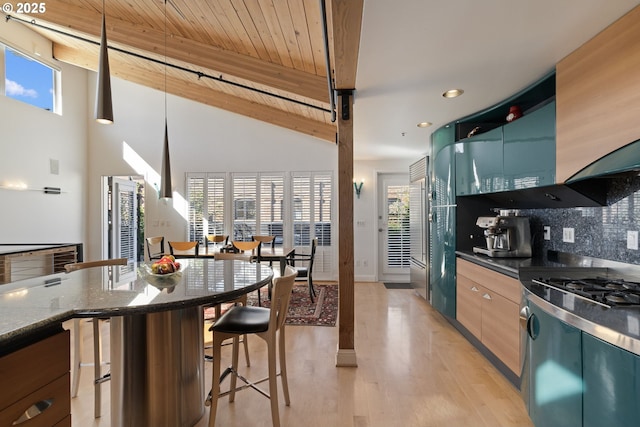 1240 NW Hoyt St Unit 6, Portland, OR 97209 - kitchen with recessed lighting, plenty of natural light, light wood-style flooring, and tasteful backsplash