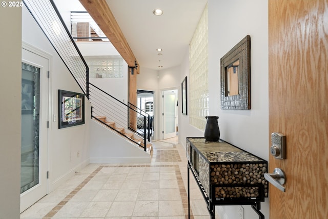 1240 NW Hoyt St Unit 6, Portland, OR 97209 - hallway with recessed lighting, stairs, baseboards, and light tile patterned flooring
