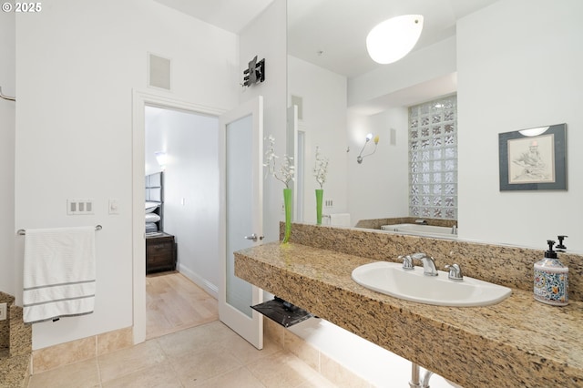 1240 NW Hoyt St Unit 6, Portland, OR 97209 - bathroom with baseboards, tile patterned floors, and a sink