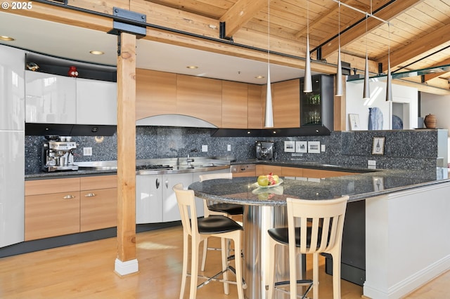1240 NW Hoyt St Unit 6, Portland, OR 97209 - kitchen with a kitchen bar, wooden ceiling, modern cabinets, and tasteful backsplash