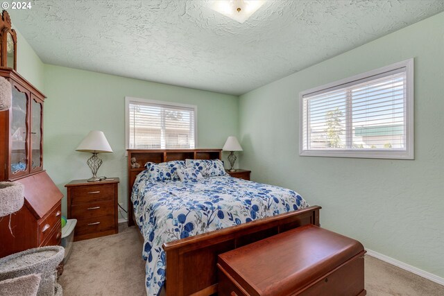 carpeted bedroom featuring a textured ceiling