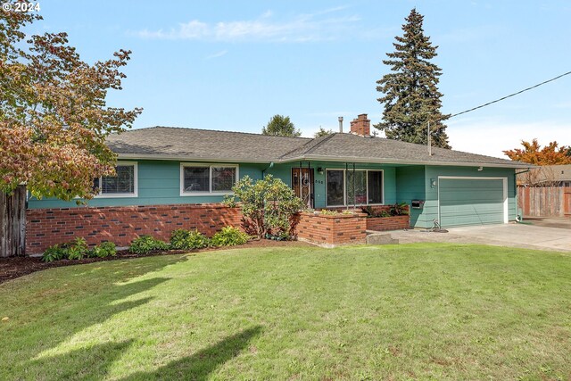 single story home with a front yard and a garage