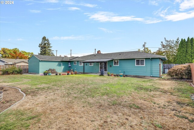 rear view of property featuring a yard