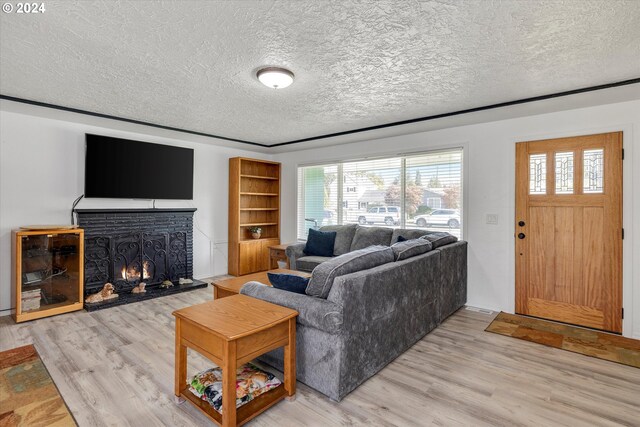 living room featuring a fireplace, hardwood / wood-style floors, and a textured ceiling