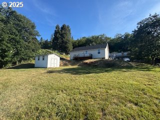 1332 SE Strong Ave, Roseburg, OR 97470 - view of grassy yard with a storage unit