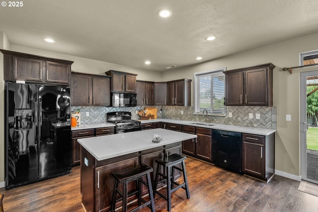 802 NW Green Forest Cir, Redmond, OR 97756 - kitchen featuring black appliances, dark brown cabinets, dark wood-type flooring, backsplash, and recessed lighting