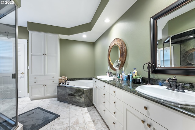 bathroom featuring vanity and shower with separate bathtub