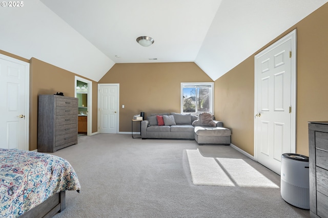 bedroom featuring lofted ceiling and light carpet