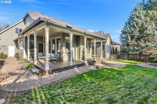 rear view of house with a patio area and a lawn