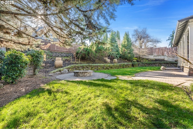 view of yard featuring a patio and an outdoor fire pit